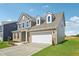 Beautiful two-story home features a brick and siding exterior with an attached two-car garage at 124 Willow Cameron Way, Angier, NC 27501
