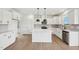 Open kitchen featuring a large island, white cabinetry, modern appliances, and seamless flow at 124 Willow Cameron Way, Angier, NC 27501