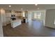 Open concept kitchen featuring white cabinets, an island with seating, and stainless steel appliances at 124 Willow Cameron Way, Angier, NC 27501