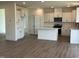 Modern kitchen with quartz countertops, stainless steel appliances, and an open-concept floor plan at 124 Willow Cameron Way, Angier, NC 27501