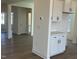 Bright kitchen featuring white cabinets, a countertop buffet area, and views into the entryway and living area at 124 Willow Cameron Way, Angier, NC 27501