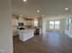 Open kitchen featuring white cabinets, an island with countertop seating, and stainless steel appliances at 124 Willow Cameron Way, Angier, NC 27501