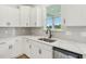 Kitchen area boasts stainless steel appliances, white cabinets, undermount sink, and bright natural light at 124 Willow Cameron Way, Angier, NC 27501