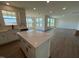 Bright, open-concept kitchen features a large island with quartz countertops and modern hardware at 124 Willow Cameron Way, Angier, NC 27501