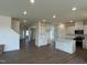 Open concept living area with wood floors connects the kitchen, entryway, and staircase at 124 Willow Cameron Way, Angier, NC 27501