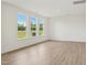 Bright living room featuring hardwood floors and large windows with scenic outdoor views at 124 Willow Cameron Way, Angier, NC 27501