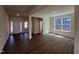 Open-concept living room featuring wood floors, white trim, and plenty of natural light from the many windows at 124 Willow Cameron Way, Angier, NC 27501