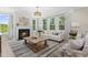 Cozy living room with a fireplace, large windows, and stylish decor at 124 Willow Cameron Way, Angier, NC 27501