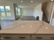 Spacious living room is bright and open with large windows, light hardwood floor, and modern finishes at 124 Willow Cameron Way, Angier, NC 27501