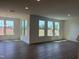Bright open concept living space features large windows with view, hardwood floors and modern chandelier at 124 Willow Cameron Way, Angier, NC 27501