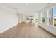 Bright, open-concept living area with hardwood flooring, open kitchen, and many windows for natural light at 124 Willow Cameron Way, Angier, NC 27501