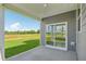 Covered patio overlooking a spacious backyard and lush greenery at 124 Willow Cameron Way, Angier, NC 27501