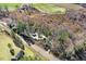 Aerial view of property showing house, outbuildings, and wooded surroundings at 12808 Old Stage Rd, Willow Springs, NC 27592