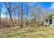 Large backyard with trees and a screened porch area at 12808 Old Stage Rd, Willow Springs, NC 27592