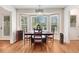 Bright dining area with bay windows and natural light, complemented by wood floors and traditional decor at 12808 Old Stage Rd, Willow Springs, NC 27592