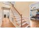 Bright foyer featuring hardwood floors, an elegant staircase, and views into adjacent rooms at 12808 Old Stage Rd, Willow Springs, NC 27592
