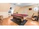 Spacious game room featuring a pool table and hardwood floors, with natural light from a window at 12808 Old Stage Rd, Willow Springs, NC 27592