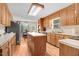Traditional kitchen featuring wooden cabinets, a center island, and natural light from a breakfast nook at 12808 Old Stage Rd, Willow Springs, NC 27592