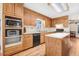 Spacious kitchen with hardwood cabinets, stainless steel appliances, and a center island for cooking at 12808 Old Stage Rd, Willow Springs, NC 27592