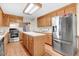 Well-equipped kitchen with oak cabinets, stainless steel appliances, and a center island at 12808 Old Stage Rd, Willow Springs, NC 27592