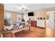 Main bedroom with wood floors, a ceiling fan, and ample natural light from two windows at 12808 Old Stage Rd, Willow Springs, NC 27592