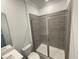 Bathroom featuring a glass enclosed shower with tile surround, toilet, and white vanity at 1308 Hazelnut Ridge Ln, Knightdale, NC 27545