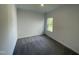 Bright bedroom featuring neutral walls and gray carpet at 1308 Hazelnut Ridge Ln, Knightdale, NC 27545