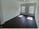 Bright room with hardwood flooring, base trim, crown molding, and natural light from two windows at 1308 Hazelnut Ridge Ln, Knightdale, NC 27545