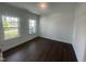Room with hardwood flooring, base trim, crown molding, and natural light from two windows at 1308 Hazelnut Ridge Ln, Knightdale, NC 27545