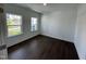 Room with hardwood flooring, base trim, crown molding, and natural light from two windows at 1308 Hazelnut Ridge Ln, Knightdale, NC 27545