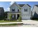 Charming two-story home with a manicured lawn, covered porch, and a two car garage at 1308 Hazelnut Ridge Ln, Knightdale, NC 27545