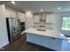 Modern kitchen with stainless steel appliances, an island with sink, and white cabinetry at 1308 Hazelnut Ridge Ln, Knightdale, NC 27545