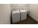 Laundry room with modern washer, dryer, sink, and wood-look flooring at 1308 Hazelnut Ridge Ln, Knightdale, NC 27545