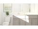 Clean bathroom with gray vanity, modern faucet and hardware, and ample storage space at 1308 Hazelnut Ridge Ln, Knightdale, NC 27545