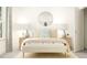 Beautiful bedroom featuring neutral tones, bedside tables, and a round mirror above the bed at 1308 Hazelnut Ridge Ln, Knightdale, NC 27545