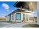 Exterior angle showcasing covered patio, stone detail, and sidewalks at 1308 Hazelnut Ridge Ln, Knightdale, NC 27545