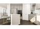 Open-concept kitchen featuring modern appliances, sleek countertops, a breakfast bar, and ample cabinet space for storage and functionality at 1308 Hazelnut Ridge Ln, Knightdale, NC 27545