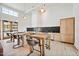 Modern communal kitchen with wooden tables, chairs, sleek appliances, and lots of natural light at 1308 Hazelnut Ridge Ln, Knightdale, NC 27545