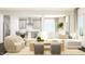 Spacious living room showcases contemporary furniture, neutral colors, and an open layout, seamlessly connecting to the kitchen area at 1308 Hazelnut Ridge Ln, Knightdale, NC 27545