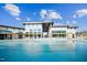 Beautiful apartment complex pool with pristine water, outdoor seating, and modern architecture at 1308 Hazelnut Ridge Ln, Knightdale, NC 27545