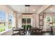 Elegant dining room with ample natural light, stylish lighting fixture, and views of the backyard at 1342 Hazelnut Ridge Ln, Knightdale, NC 27545