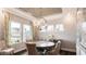 Formal dining room with large windows, elegant chandelier, and stylish seating at 1342 Hazelnut Ridge Ln, Knightdale, NC 27545