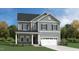 Charming two-story home with gray siding, stone accents, and a welcoming front porch at 1342 Hazelnut Ridge Ln, Knightdale, NC 27545