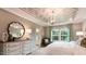 A bedroom with a unique ceiling design and a large window providing natural light at 1342 Hazelnut Ridge Ln, Knightdale, NC 27545