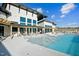 Resort-style pool area with modern building, sun loungers, and outdoor dining spaces at 1342 Hazelnut Ridge Ln, Knightdale, NC 27545