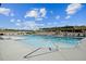 Inviting pool area with clear blue water, comfortable loungers, and a shaded pergola at 1342 Hazelnut Ridge Ln, Knightdale, NC 27545