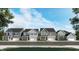 A picturesque streetscape featuring a row of beautifully designed homes with varied architectural styles at 1342 Hazelnut Ridge Ln, Knightdale, NC 27545