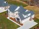 High-angle view of a brick home with a large driveway and well-kept yard at 149 Bonica Creek Dr, Garner, NC 27529