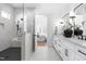 Open bathroom featuring dual vanities, black accents and a large shower with gray tile at 149 Bonica Creek Dr, Garner, NC 27529