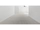 Carpeted bedroom with neutral walls and a view of an open door and ceiling fan at 149 Bonica Creek Dr, Garner, NC 27529